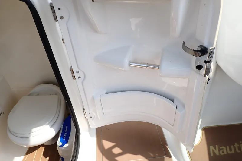 Slide: The Image of Interior view of 2019 NauticStar 243DC Sport Deck boat's restroom area. - 43