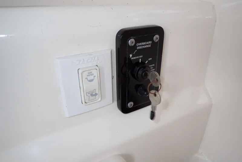 Slide: The Image of Control panel with keys on a 2019 NauticStar 243DC Sport Deck boat. - 45