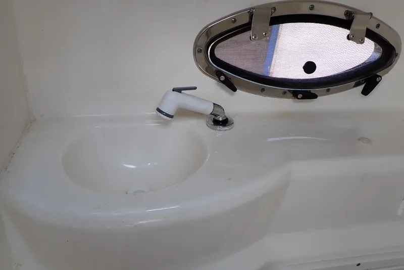 Slide: The Image of 2019 NauticStar 243DC Sport Deck boat sink with oval porthole window. - 46