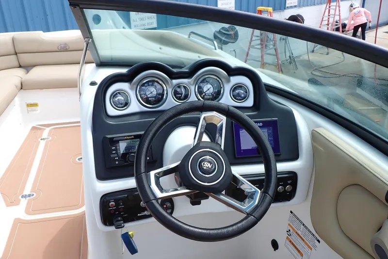 Slide: The Image of 2019 NauticStar 243DC Sport Deck boat dashboard with steering wheel and gauges. - 6