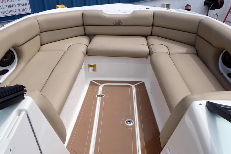 Slide: The Image of 2019 NauticStar 243DC Sport Deck boat with beige cushioned seating. - 7