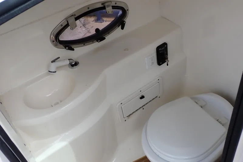 Slide: The Image of 2019 NauticStar 243DC Sport Deck boat bathroom with sink and toilet. - 9