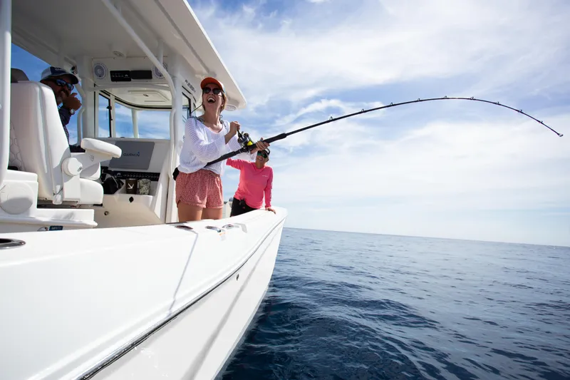 Slide: The Image of People fishing on a 2026 World Cat 295CC boat in open water. - 11