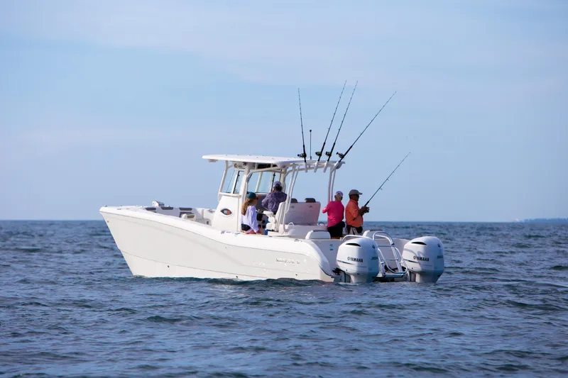 Slide: The Image of 2026 World Cat 295CC boat with anglers fishing on open water. - 13