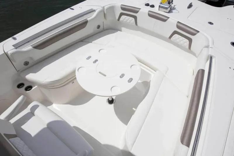 Slide: The Image of 2026 World Cat 295CC boat interior with white seating and round table. - 17