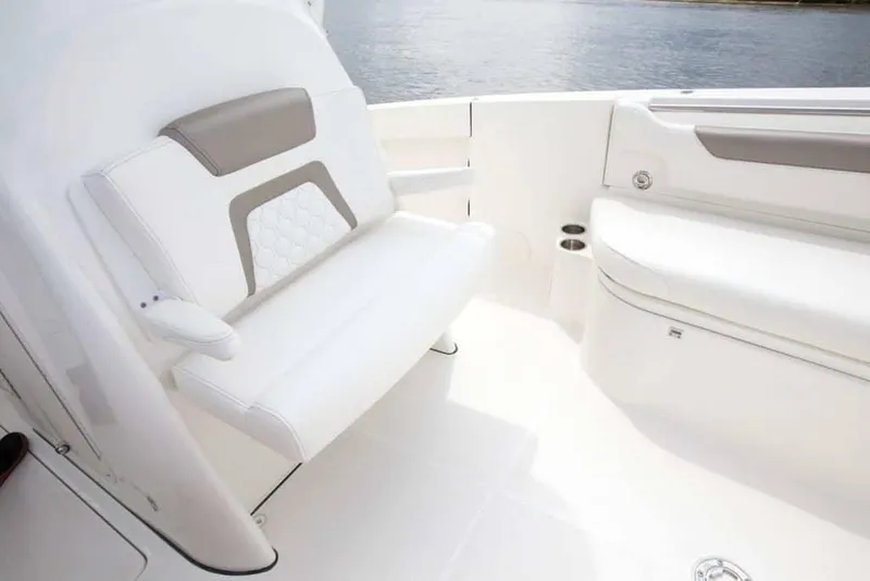 Slide: The Image of 2026 World Cat 295CC boat interior with white seating and cup holders. - 18