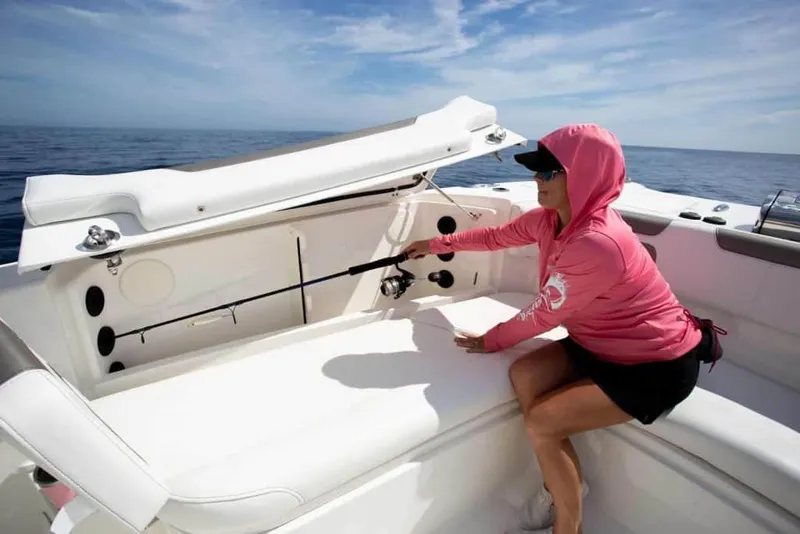 Slide: The Image of Woman storing fishing rod on 2026 World Cat 295CC boat under clear sky. - 22