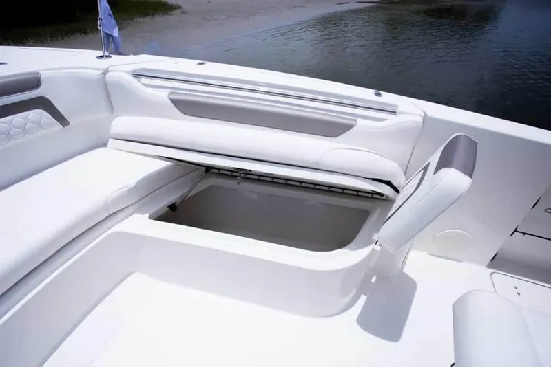 Slide: The Image of 2026 World Cat 295CC boat with open storage compartment, white seating, and sleek design. - 25