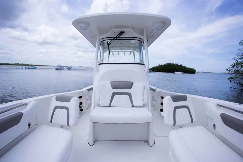 Slide: The Image of 2026 World Cat 295CC boat interior with seating, on a calm water backdrop. - 27