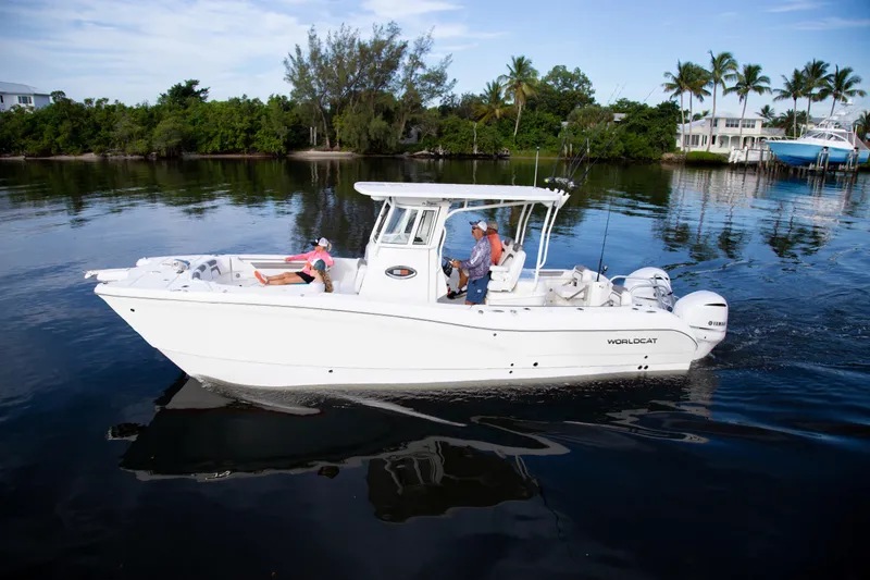 Slide: The Image of 2026 World Cat 295CC boat cruising on calm water with passengers onboard. - 3