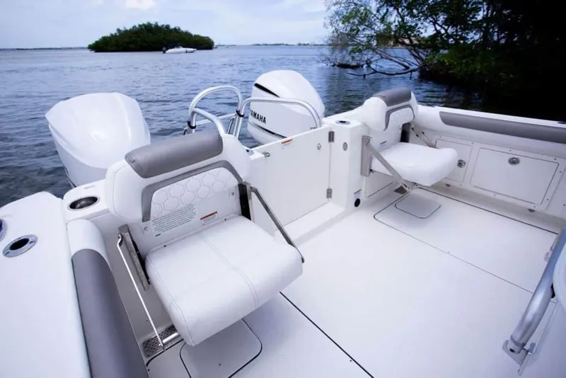 Slide: The Image of 2026 World Cat 295CC boat interior with seating, near water and trees. - 32