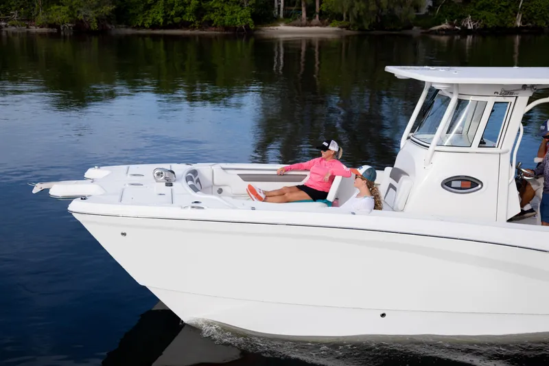 Slide: The Image of 2026 World Cat 295CC boat cruising on calm water with passengers relaxing onboard. - 4