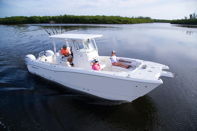 Slide: The Image of 2026 World Cat 295CC boat cruising on calm water with passengers relaxing. - 7
