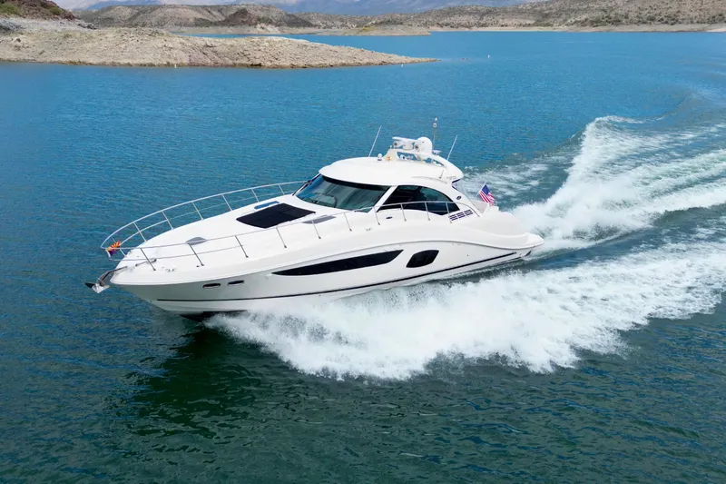 The Image of 2014 Sea Ray 580 Sundancer yacht cruising on a clear blue lake. - 0