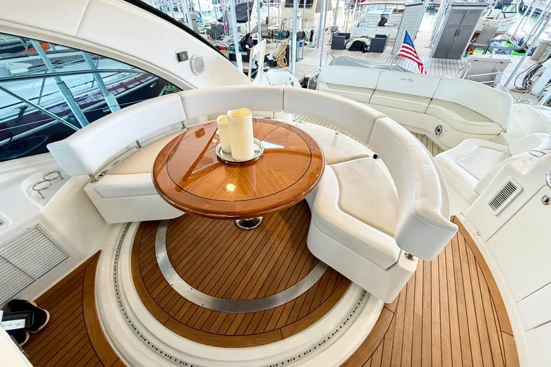Slide: The Image of Luxurious 2014 Sea Ray 580 Sundancer yacht interior with elegant seating and wooden table. - 10