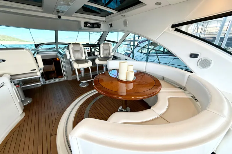 Slide: The Image of Luxurious interior of 2014 Sea Ray 580 Sundancer yacht with elegant seating and wooden table. - 11
