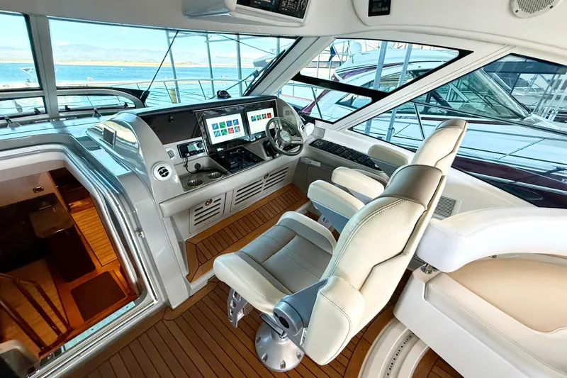 Slide: The Image of Luxurious helm of 2014 Sea Ray 580 Sundancer yacht with modern controls and leather seating. - 12