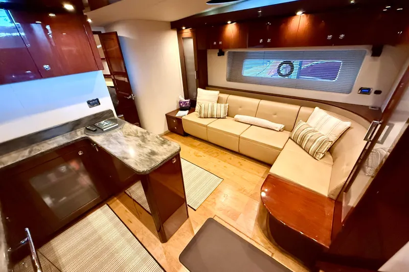 Slide: The Image of Luxurious interior of 2014 Sea Ray 580 Sundancer yacht with elegant seating and modern kitchen. - 18