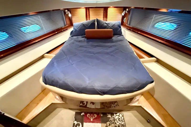 Slide: The Image of Luxurious cabin interior of 2014 Sea Ray 580 Sundancer yacht with blue bedding. - 21