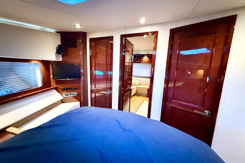 Slide: The Image of Luxurious interior of 2014 Sea Ray 580 Sundancer yacht with wood finishes and modern amenities. - 22