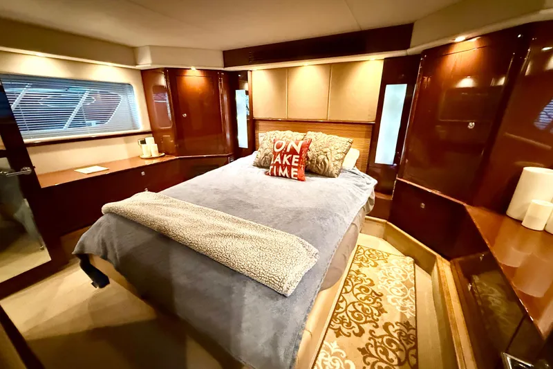 Slide: The Image of Luxurious bedroom interior of 2014 Sea Ray 580 Sundancer yacht with elegant wood finishes. - 28