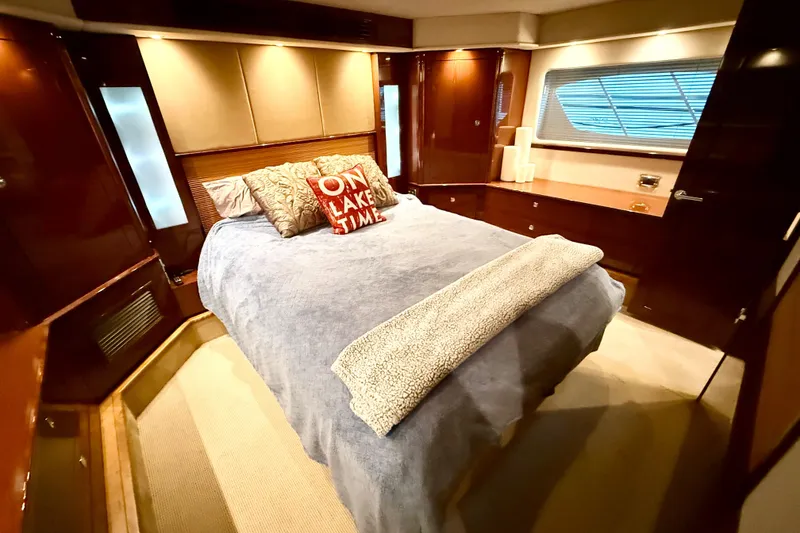 Slide: The Image of Luxurious bedroom interior of 2014 Sea Ray 580 Sundancer yacht with cozy bedding. - 29
