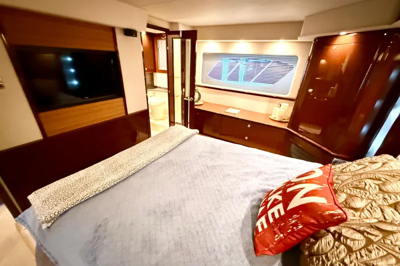 Slide: The Image of Luxurious 2014 Sea Ray 580 Sundancer yacht bedroom with elegant decor and modern amenities. - 31