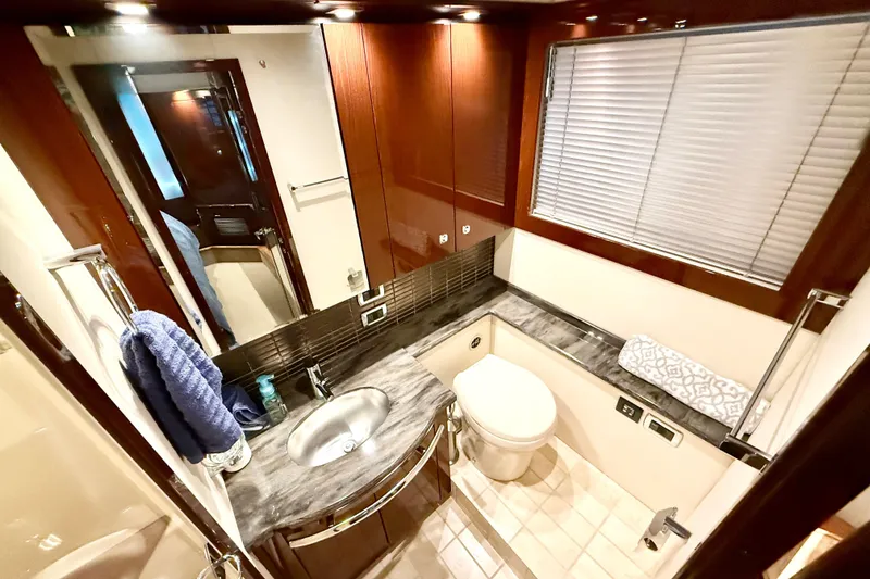 Slide: The Image of Luxurious bathroom in 2014 Sea Ray 580 Sundancer yacht with modern fixtures and elegant design. - 32