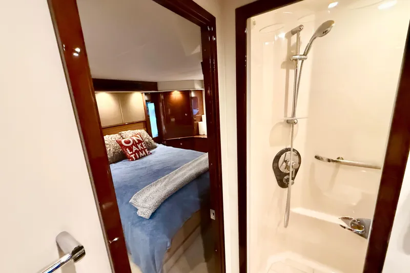 Slide: The Image of 2014 Sea Ray 580 Sundancer interior with cozy bedroom and modern shower. - 34