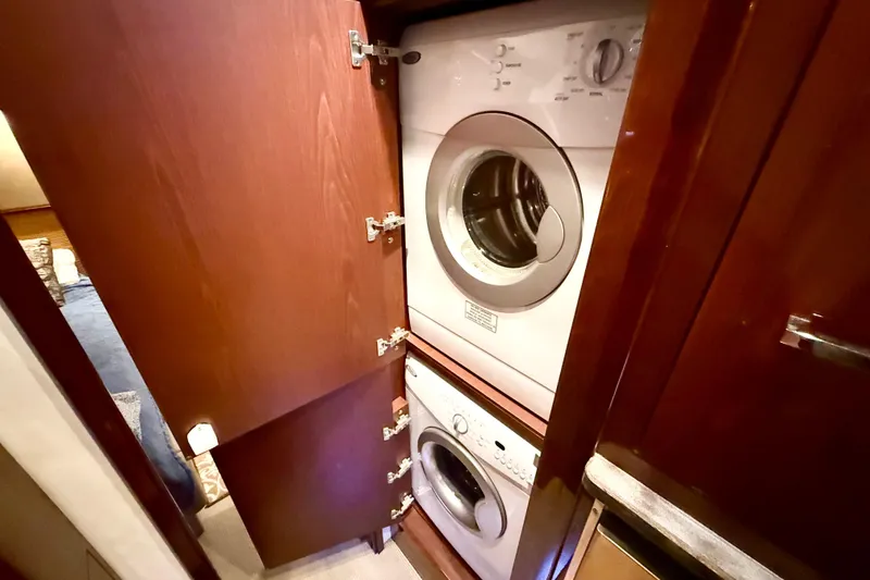 Slide: The Image of Laundry area with stacked washer and dryer in 2014 Sea Ray 580 Sundancer yacht. - 35