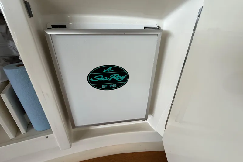 Slide: The Image of Sea Ray 580 Sundancer 2014 interior cabinet with logo, featuring sleek design. - 50