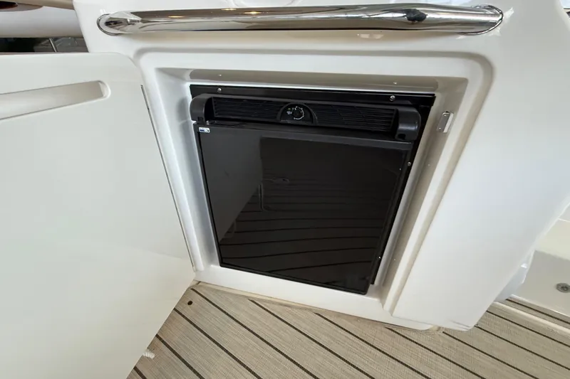 Slide: The Image of Mini fridge on 2014 Sea Ray 580 Sundancer yacht, open cabinet view. - 51
