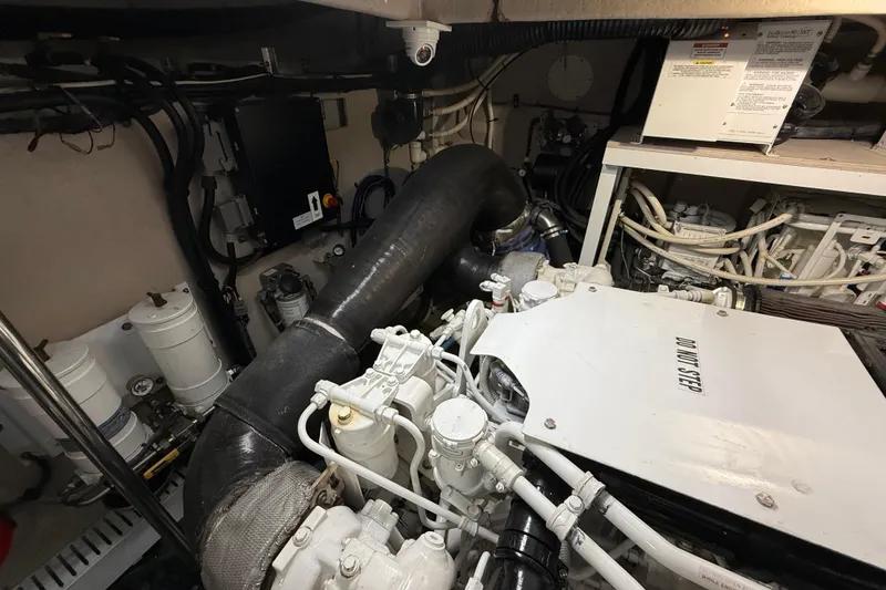 Slide: The Image of Engine room of 2014 Sea Ray 580 Sundancer with visible machinery and components. - 52