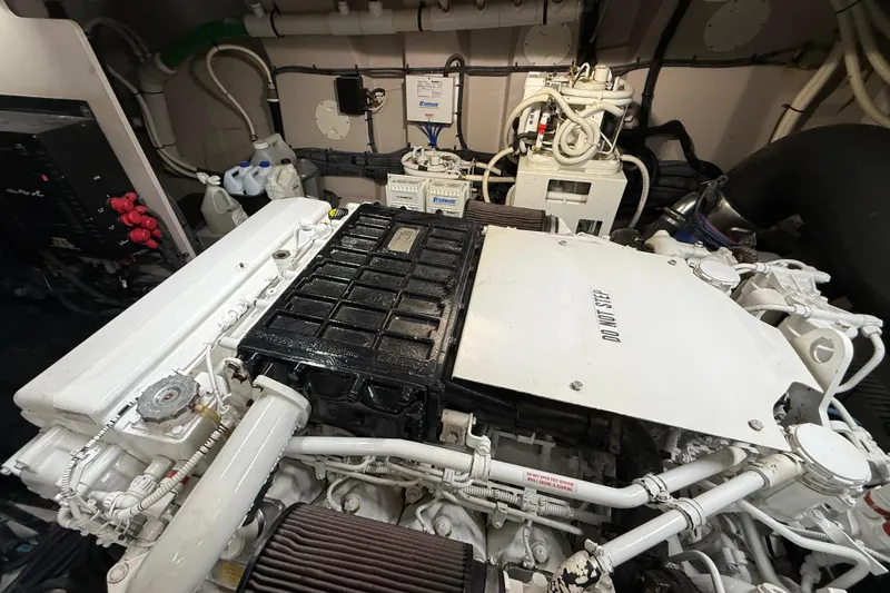 Slide: The Image of Engine room of a 2014 Sea Ray 580 Sundancer yacht, showcasing mechanical components. - 57
