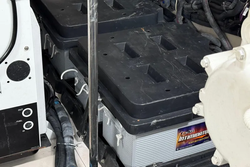 Slide: The Image of 2014 Sea Ray 580 Sundancer engine room with heavy-duty batteries and wiring. - 58