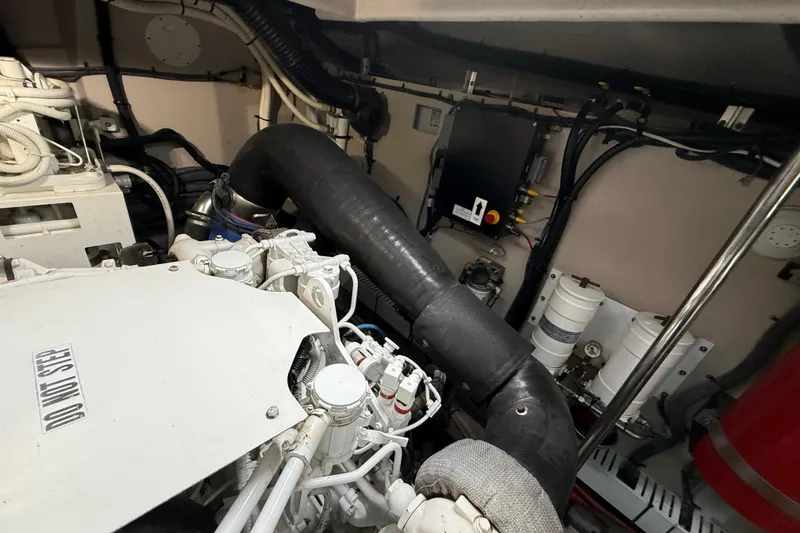 Slide: The Image of Engine room of 2014 Sea Ray 580 Sundancer with visible components and piping. - 59
