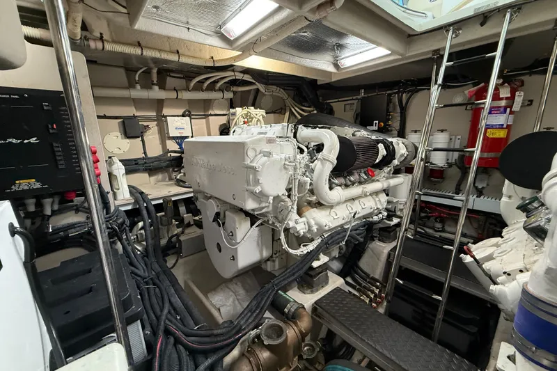 Slide: The Image of Engine room of a 2014 Sea Ray 580 Sundancer yacht, showcasing machinery and equipment. - 61