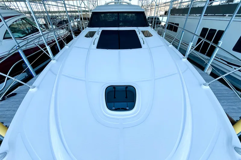 Slide: The Image of 2014 Sea Ray 580 Sundancer yacht docked in a marina, showcasing sleek design. - 63