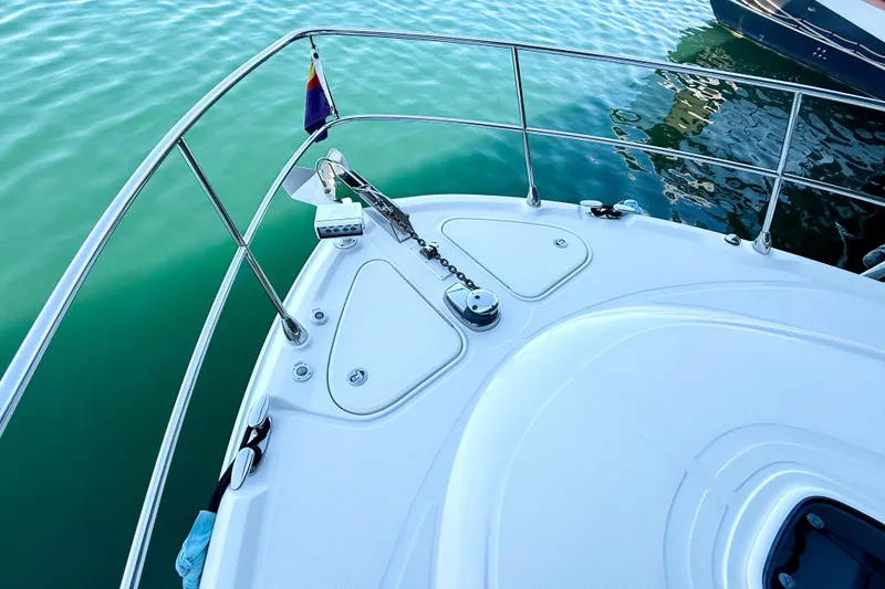 Slide: The Image of Bow of 2014 Sea Ray 580 Sundancer yacht on calm water. - 65