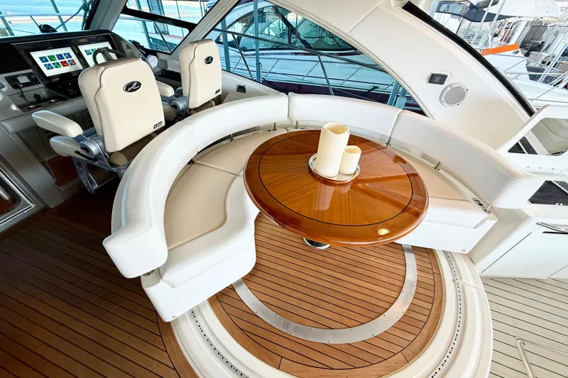 Slide: The Image of Luxurious 2014 Sea Ray 580 Sundancer yacht interior with elegant seating and wooden table. - 9