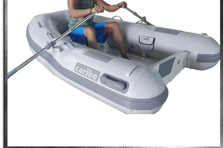 Slide: The Image of Person rowing a 2025 Caribe C9X inflatable boat, showcasing its design and features. - 9