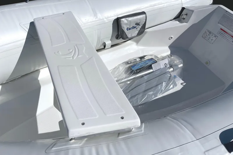 Slide: The Image of Interior of 2025 Caribe L8 inflatable boat with storage compartment and accessories. - 13
