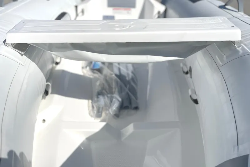 Slide: The Image of Inflatable boat interior, Caribe L8 2025 model, featuring a white bench seat. - 15