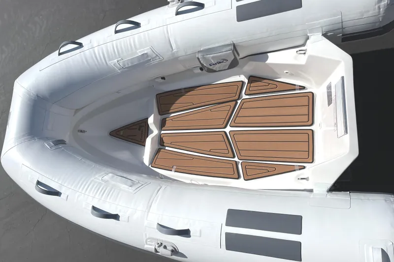 Slide: The Image of Inflatable boat interior with wooden floor panels, Caribe L8 model, 2025. - 19