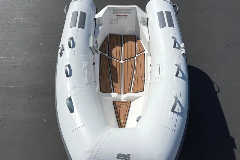 Slide: The Image of Inflatable Caribe L8 boat, 2025 model, with wooden floor panels, viewed from above. - 20