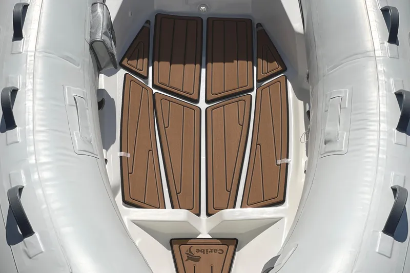 Slide: The Image of Inflatable boat interior with brown deck, Caribe L8, 2025 model. - 21