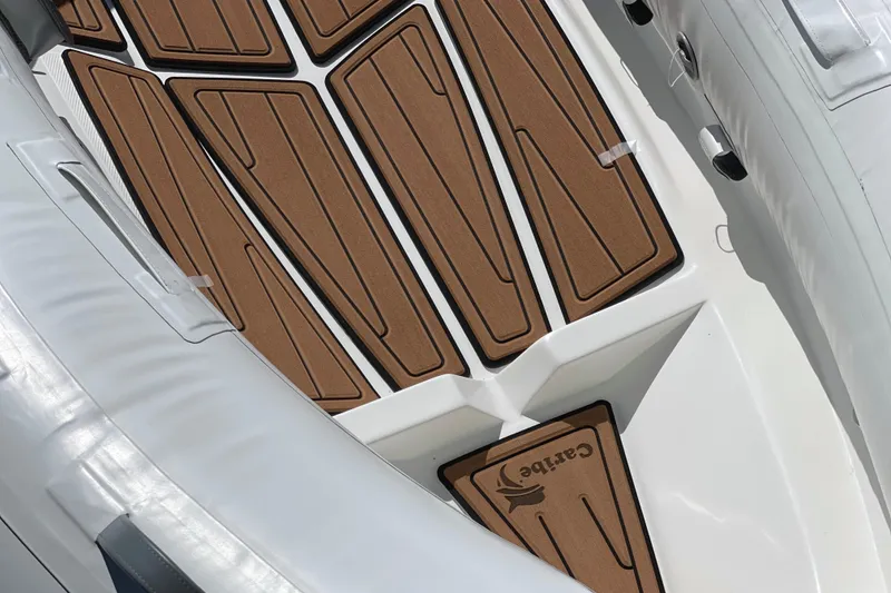 Slide: The Image of Inflatable boat interior with brown non-slip flooring, Caribe L8, 2025 model. - 24