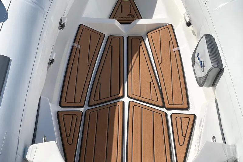 Slide: The Image of Interior view of 2025 Caribe L8 boat with teak-style flooring. - 25