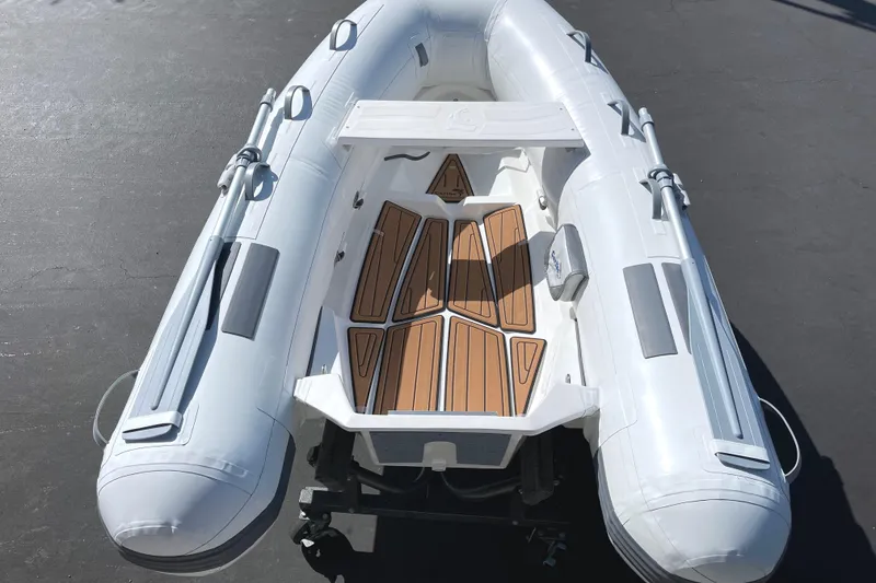 Slide: The Image of 2025 Caribe L8 inflatable boat with wooden deck, viewed from above. - 27