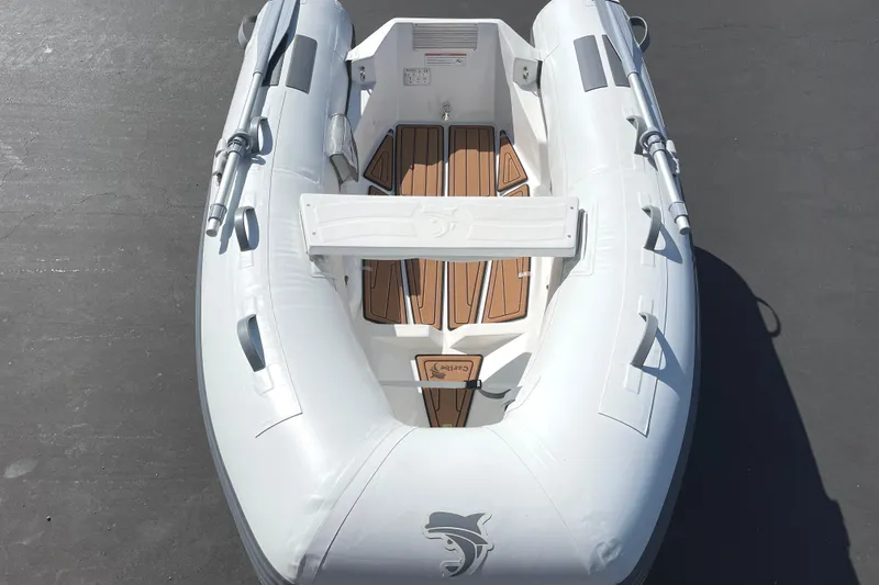 Slide: The Image of Inflatable Caribe L8 boat, 2025 model, with wooden floor accents and oars. - 28